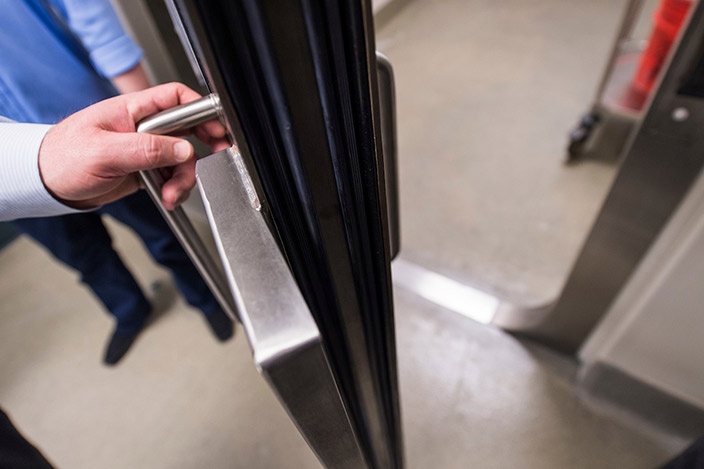 An equipment exchange airlock door is seen in a high-security research facility.