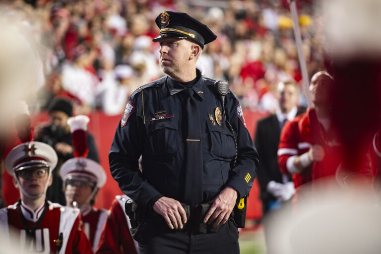 police officer at Camp Randal Stadium watching crowd